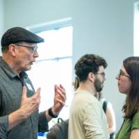 Student chatting with event attendee